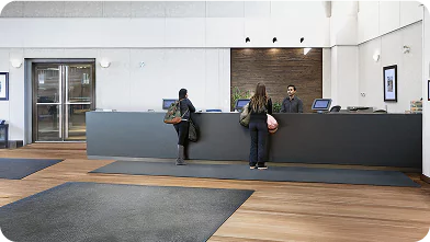 Guests checking in at a reception desk in a remote workforce camp or remote accommodation facility.