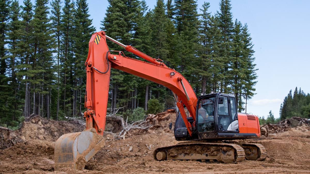 Excavator moving dirt at remote construction site