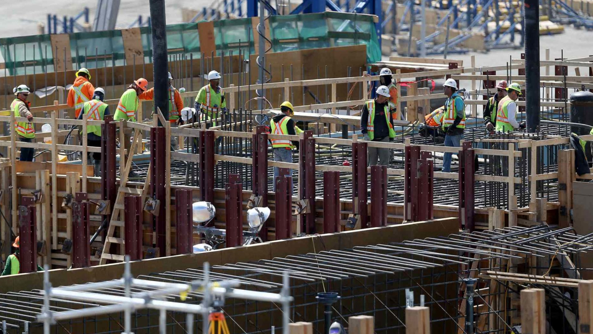 Workers laboring during day at construction site