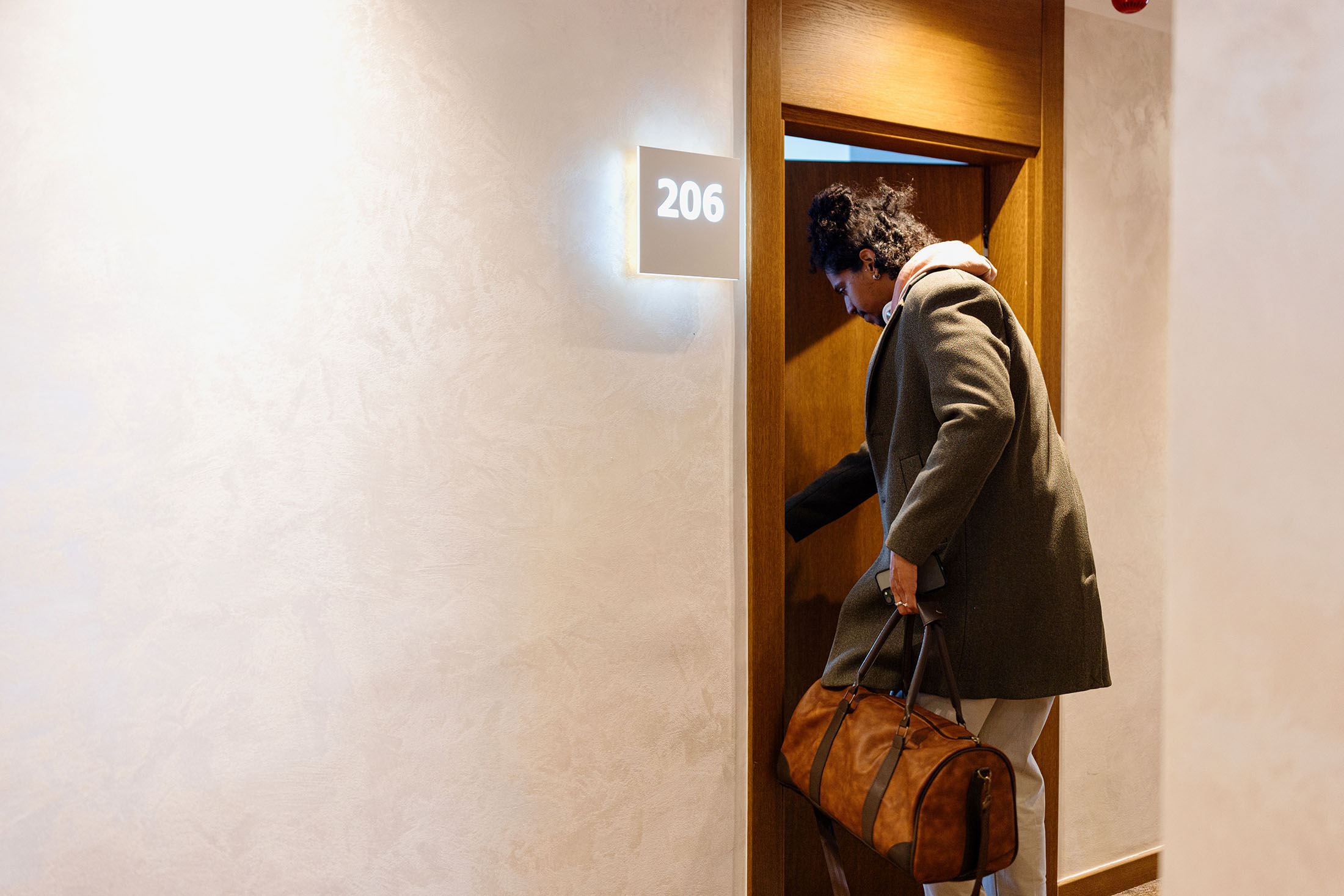 man-entering-hotel-room