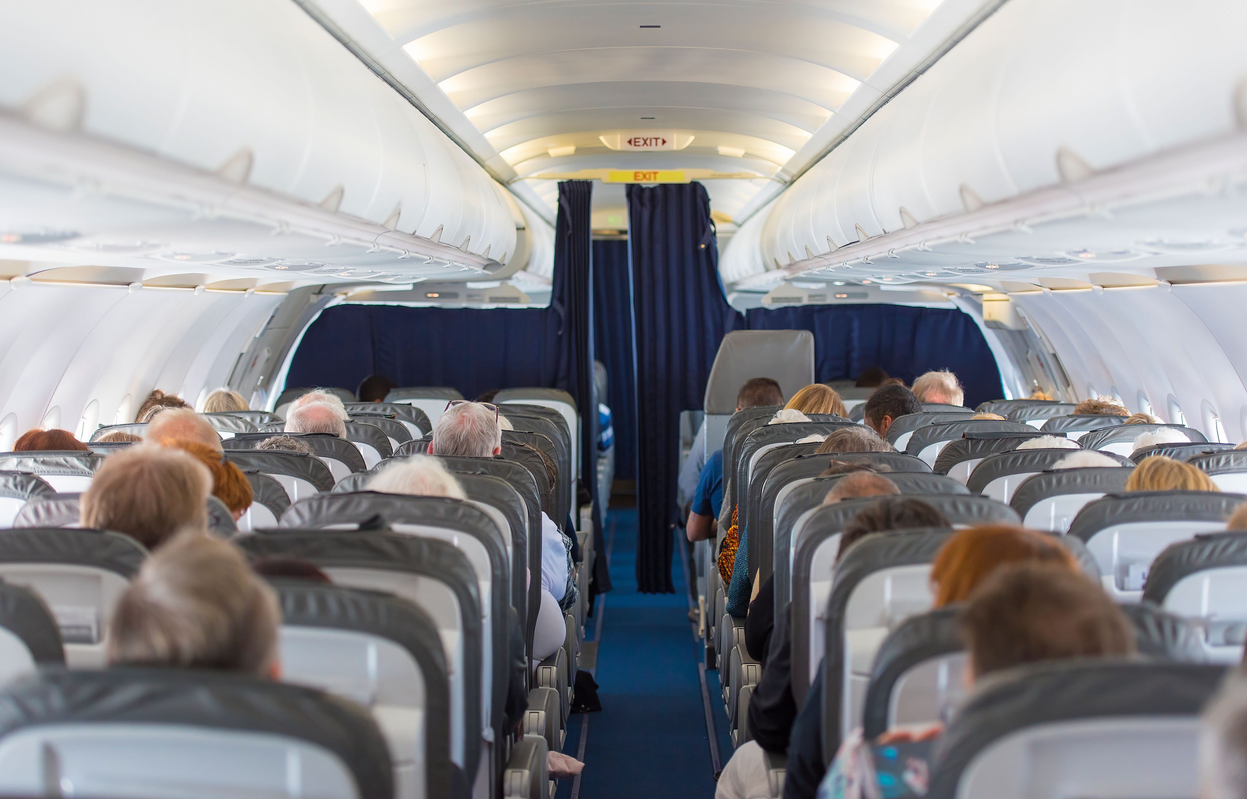 people-seated-rows-commercial-plane