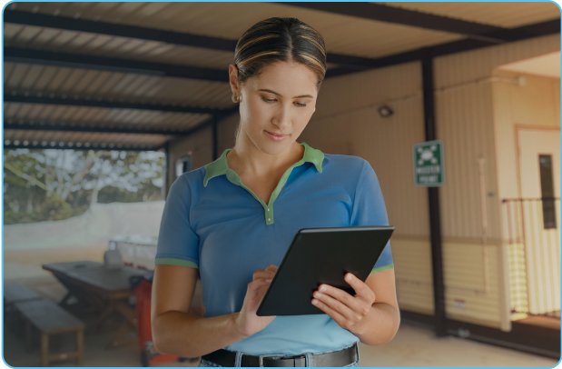 Camp management company staff reviews ipad in remote camp setting.