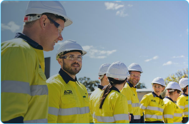 FIFO workers in uniform chat among each other during sunny day.