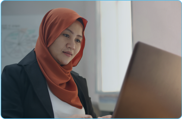 Front desk receptionist at mining housing facilities studies computer screen.