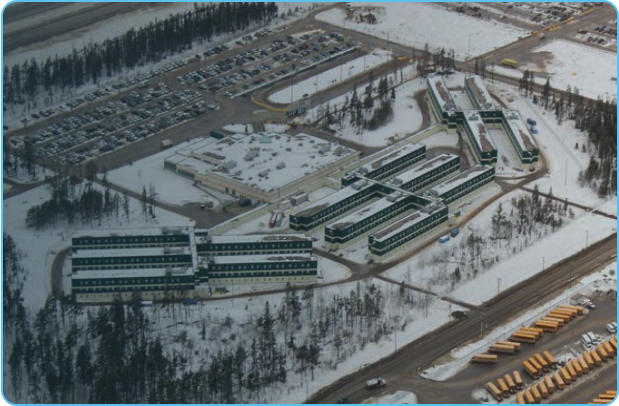 Aerial view of a remote workforce housing site in a winter setting.