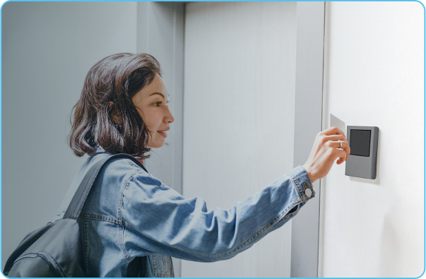 Female workers taps keycard to enter bedroom at remote camp.