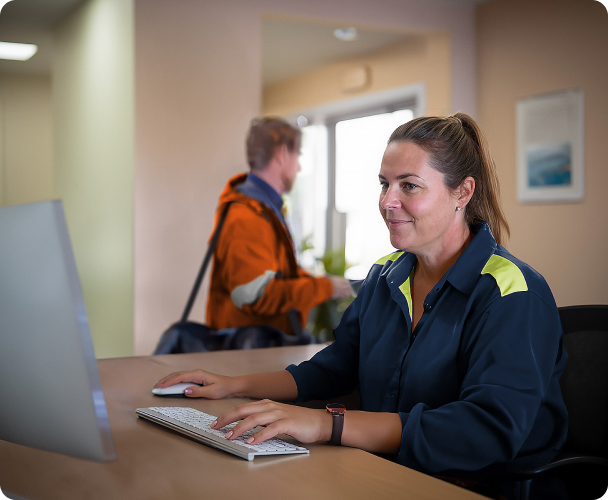 Receptionist at remote camp works at computer