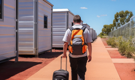 Project personnel walks to room at mining camp