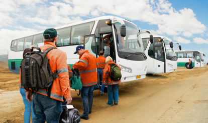 Fly in fly out workers board white bus