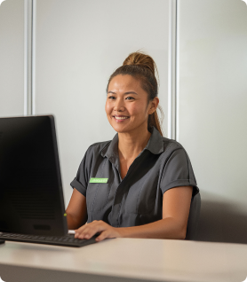 Staff member working at a front desk of a remote camp.