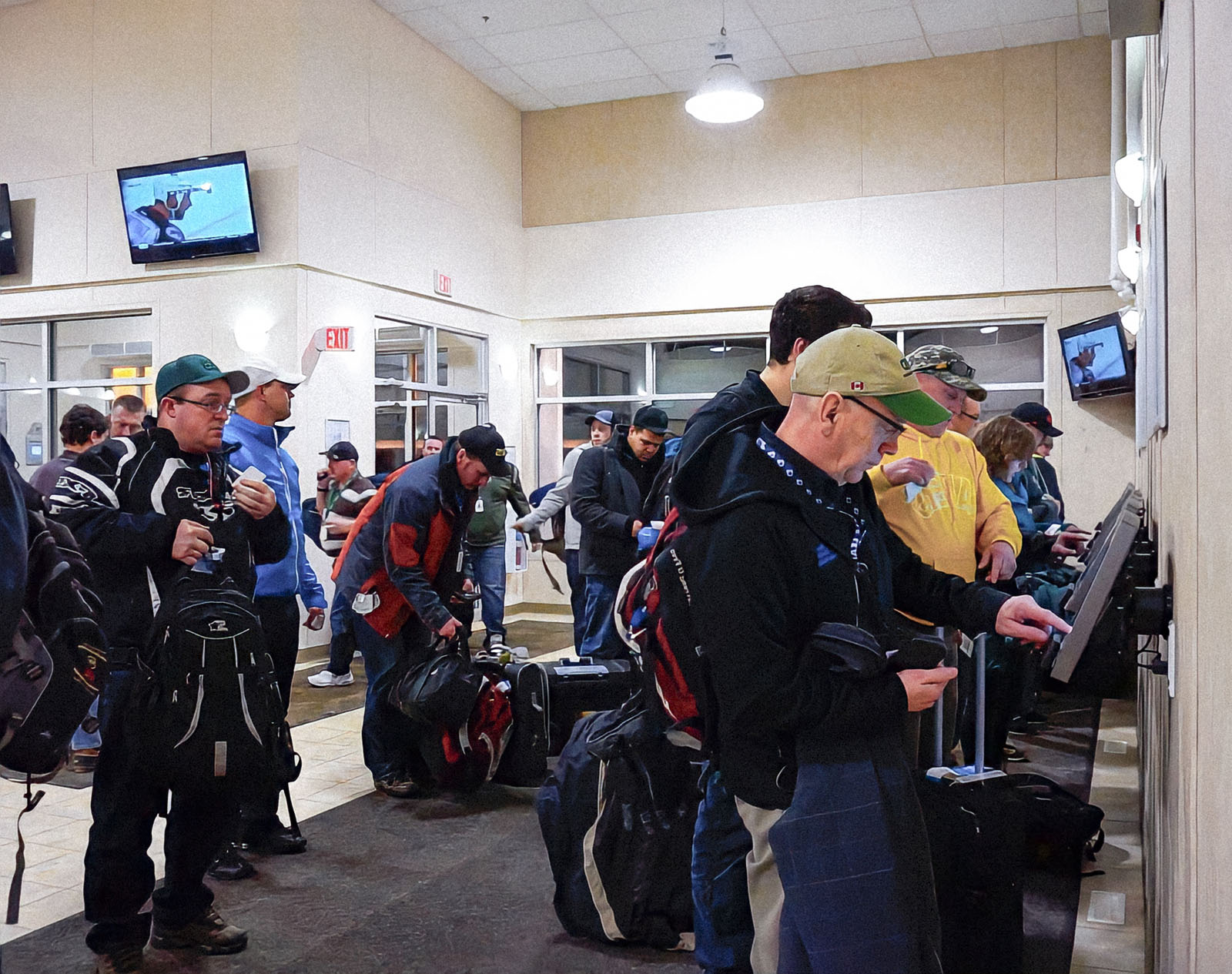 Workers use kiosks to check in at a lobby located an oil sands camp in Fort McMurray, Canada.