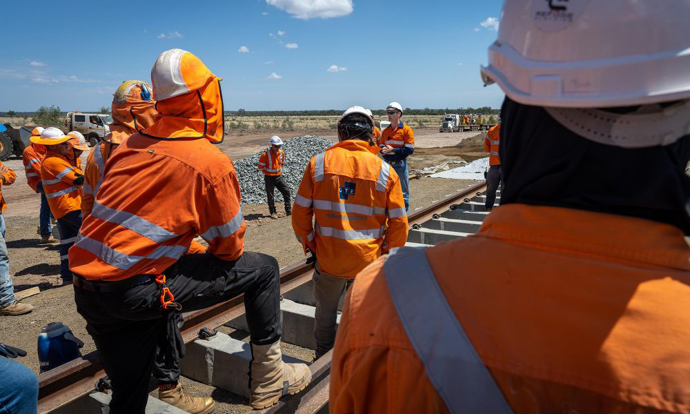 FIFO workers congregate outside at a project site.